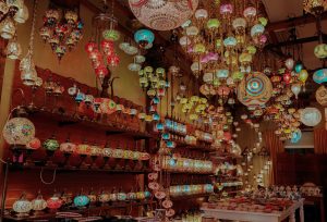 a store filled with lots of colorful lights hanging from the ceiling